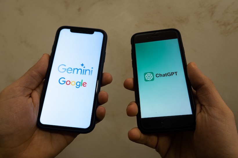 Hands holding smartphones with Google Gemini and ChatGPT logos