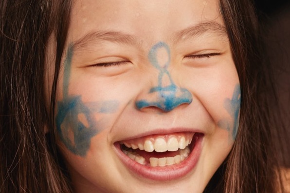 Girl smiling and wearing facepaint