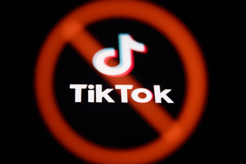TikTok logo with red strike through it