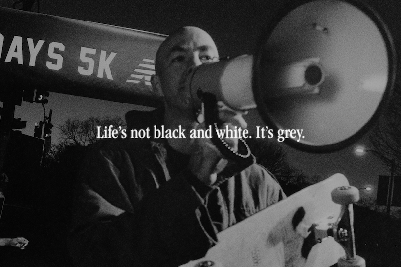 New Balance Grey Day ad featuring man speaking into a bullhorn
